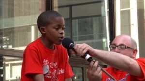 Third grader Asean Johnson openly calls the school closings racist at a rally on Daily Plaza this past Monday.